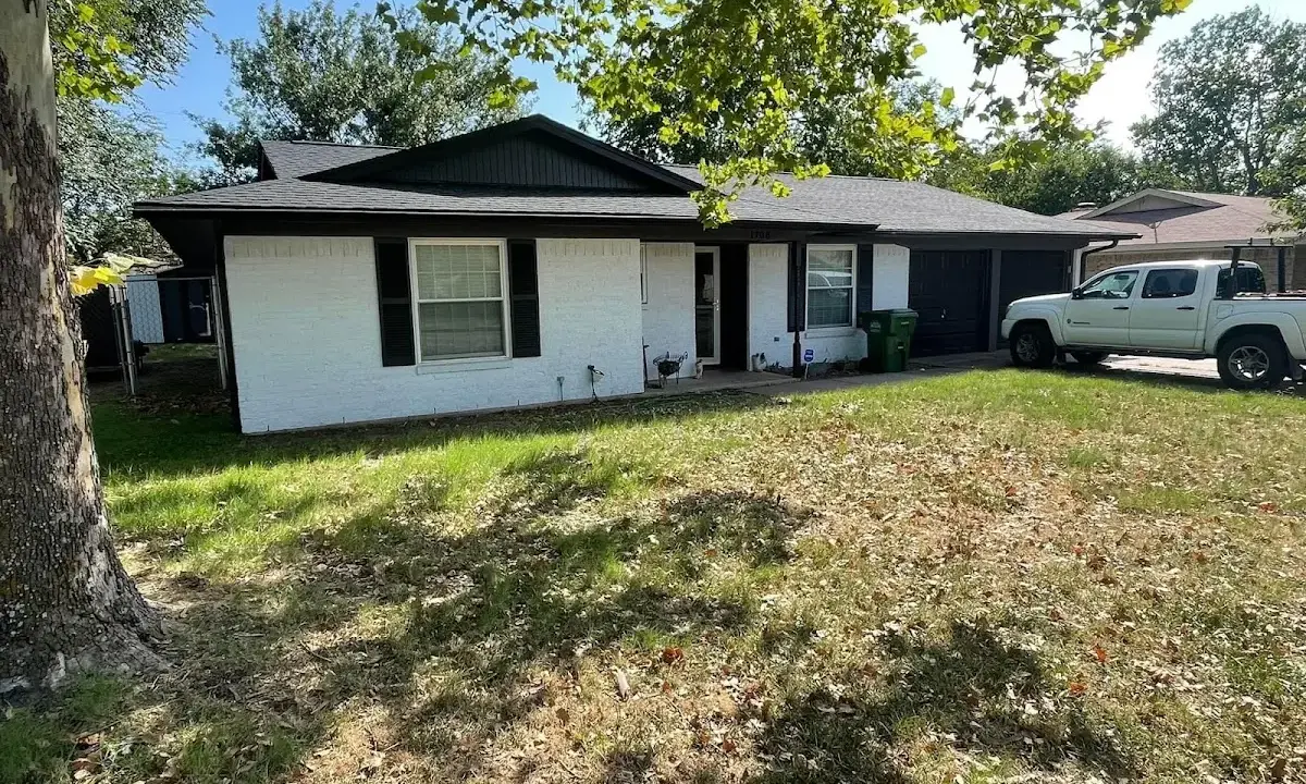 Professional roofing crew working on a residential roof in Ennis